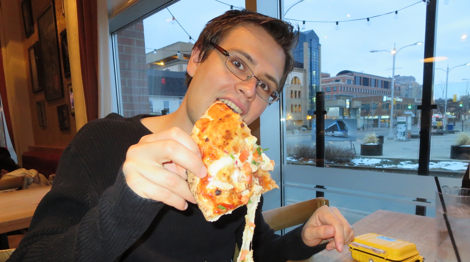 Matt chowing down on pizza.